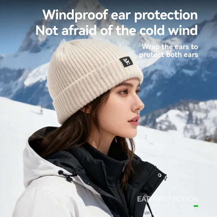 Person wearing a windproof ear protection product in a snowy mountain setting